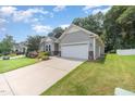 Charming single-story home with a well-manicured lawn and a two-car garage at 3037 Willow Ranch Dr, Fuquay Varina, NC 27526