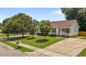 Inviting single-story home with a spacious driveway and a beautifully landscaped front yard at 304 Quailwood Dr, Fuquay Varina, NC 27526