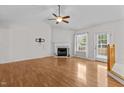 Bright and airy living room featuring vaulted ceilings, a fireplace, and wood-look flooring at 304 Quailwood Dr, Fuquay Varina, NC 27526