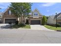 Charming home featuring stone accents, a well-manicured lawn, and an attached two-car garage at 3207 Imperial Oaks Dr, Raleigh, NC 27614