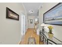 Inviting hallway with hardwood floors, neutral walls, and elegant decor, leading to the main living spaces at 3207 Imperial Oaks Dr, Raleigh, NC 27614