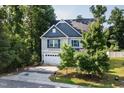 Beautiful two-story home with a well-manicured lawn, blue accents, and attached two-car garage at 3401 Grosbeak Way, Raleigh, NC 27616