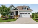 Inviting home exterior showcasing well-maintained landscaping, stone pillars, and a two-car garage at 365 Middleton Pl, Chapel Hill, NC 27516