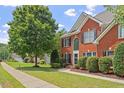 Stately brick home with mature trees, manicured lawn, and a welcoming facade at 3812 Covina Dr, Raleigh, NC 27613
