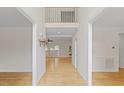 Bright foyer featuring gleaming hardwood floors and a view of the upper level at 3812 Covina Dr, Raleigh, NC 27613