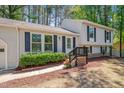 Home featuring lovely landscaping, neutral siding, and black shutters on the windows at 403 Carpenter Fletcher Rd, Durham, NC 27713