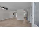 Open-concept living room with a ceiling fan, hardwood floors, and lots of natural light at 403 Carpenter Fletcher Rd, Durham, NC 27713