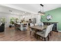 Open-concept kitchen with a large island, stainless steel appliances, and an adjacent dining area with wood floors at 404 Blooming Meadows Rd, Holly Springs, NC 27540