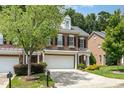 Attractive brick townhome boasting a two-car garage, manicured lawn, and lovely curb appeal at 4060 Barton Park Pl, Raleigh, NC 27613