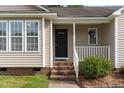 Close-up view of the home's entrance, featuring a quaint porch and stylish front door at 432 Barn View Ct, Fuquay Varina, NC 27526