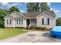 Attractive single-story home featuring a cozy front porch and a convenient driveway at 432 Barn View Ct, Fuquay Varina, NC 27526