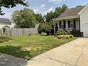Beautifully landscaped front yard featuring a lush green lawn and charming curb appeal at 44 Glen Meadow Dr, Angier, NC 27501
