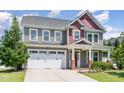 Charming two-story home boasts an inviting front entrance with brick accents and a manicured lawn at 4505 Wingate Song Ct, Knightdale, NC 27545