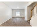 Spacious living room with carpet flooring, neutral walls, and a staircase to the second level at 4802 Parkville Dr, Raleigh, NC 27604