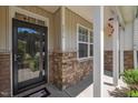 Close-up of a home's entry featuring a glass door and decorative accents on the porch at 5216 Marcella Ct, Durham, NC 27707