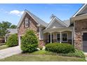 Inviting home with stone accents, lush landscaping, and a covered front porch at 5216 Marcella Ct, Durham, NC 27707