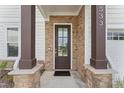Stylish front door with stone accents and modern hardware at 533 Kings Lake Way, Durham, NC 27703