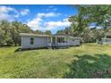 Exterior view of a one-story home with a front porch and grassy yard at 64 Doughty Ln # E, Middlesex, NC 27557