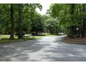Picturesque neighborhood street lined with mature trees, creating a serene and inviting atmosphere at 747 Weathergreen Dr, Raleigh, NC 27615
