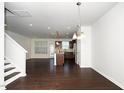 Open-concept living room with hardwood floors, stairs and lots of natural light at 835 New Derby Ln, Apex, NC 27523