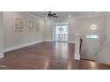 Bright, open living room with hardwood floors and balcony access, perfect for relaxing or entertaining at 10330 Sablewood Dr # 104, Raleigh, NC 27617