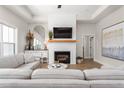 Bright living room featuring a fireplace, wood floors, and stylish neutral decor at 1050 Southern High School Rd, Burlington, NC 27215