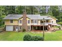 Spacious backyard with a large brick chimney and deck perfect for outdoor entertaining at 106 Autumn Cir, Cary, NC 27518