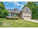 Charming two-story home with a well-manicured lawn and attached two-car garage at 109 Box Elder Way, Zebulon, NC 27597