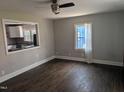 Bright living room with hardwood floors and a passthrough to the kitchen at 1102 N Guthrie Ave, Durham, NC 27703