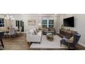 Open-concept living room with hardwood floors, stylish furnishings, and modern decor at 1102 Red Roses Ave, Durham, NC 27703