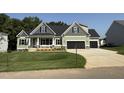 New construction featuring a spacious lawn, a black roof, and a 3-car garage at 111 Hot Springs Way, Benson, NC 27504