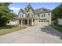 Beautiful two-story home with a well-manicured lawn and a spacious driveway leading to an attached garage at 1133 Heritage Greens Dr, Wake Forest, NC 27587