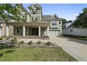 Charming two-story home with covered porch, columns, flower boxes, and an attached garage at 1133 Heritage Greens Dr, Wake Forest, NC 27587
