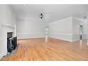 Bright living room with hardwood floors, white trim, and a cozy fireplace, ideal for gatherings at 1230 Sykes Rd, Spring Hope, NC 27882