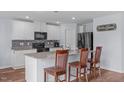 Bright kitchen featuring granite countertops and stainless steel appliances at 124 Lahinch Dr, Fuquay Varina, NC 27526