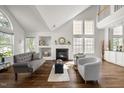 Inviting living room features a fireplace, built-in shelving, and large windows for plenty of natural light at 1308 Snyder St, Durham, NC 27713