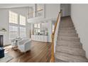 Bright living room with vaulted ceilings, hardwood floors, and stairs leading up to the second floor at 1308 Snyder St, Durham, NC 27713