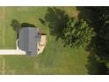An aerial view showcasing a home with an expansive green lawn and a deck at 139 His Way, Middlesex, NC 27557