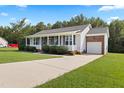 Traditional home boasting a long driveway and a convenient attached garage at 139 His Way, Middlesex, NC 27557