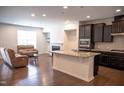 Open-concept kitchen featuring stainless steel appliances and an island, perfect for entertaining at 1402 Southpoint Trl, Durham, NC 27713