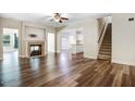 Inviting living room features a cozy fireplace, hardwood floors, and an open layout at 147 Everwood Dr, Four Oaks, NC 27524