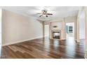 Spacious living room showcasing a fireplace, modern hardwood floors, and neutral paint at 147 Everwood Dr, Four Oaks, NC 27524