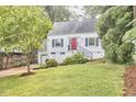 Charming home boasts a well-manicured lawn, bright red door, and attached garage at 1516 Edgevale Rd, Durham, NC 27701