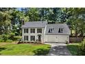 Charming two-story home with black shutters, new roof and manicured lawn at 1609 Falls Ct, Raleigh, NC 27615