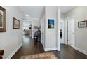 Hallway featuring wood floors and neutral walls with decorative accents at 1918 Morning Fog Dr, Fuquay Varina, NC 27526