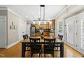 Inviting dining room with wood table and chairs adjacent to the kitchen, bright space at 204 Edgepine Dr, Holly Springs, NC 27540