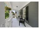Inviting front porch with seating, offering a relaxing outdoor space with black shutters at 204 Edgepine Dr, Holly Springs, NC 27540