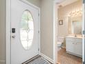 Bright entryway featuring a stylish front door and a convenient half-bathroom nearby at 25 Silver Pl # Apt B, Angier, NC 27501