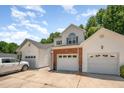 Spacious three-car garage with ample parking and storage, complemented by lush greenery at 25 Silver Pl # Apt B, Angier, NC 27501