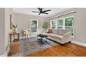 Inviting living room featuring hardwood floors, a ceiling fan, and bright windows at 2503 Shirley St, Durham, NC 27705